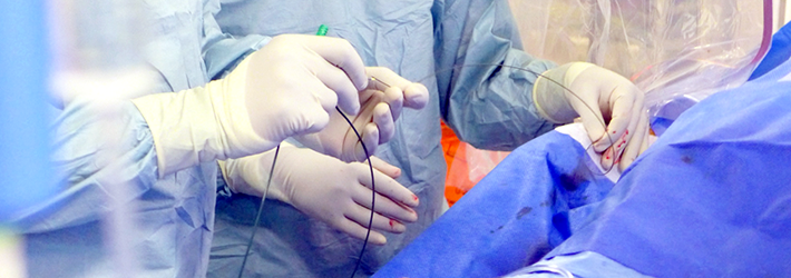 Photograph of physicians operating in a catheter lab.